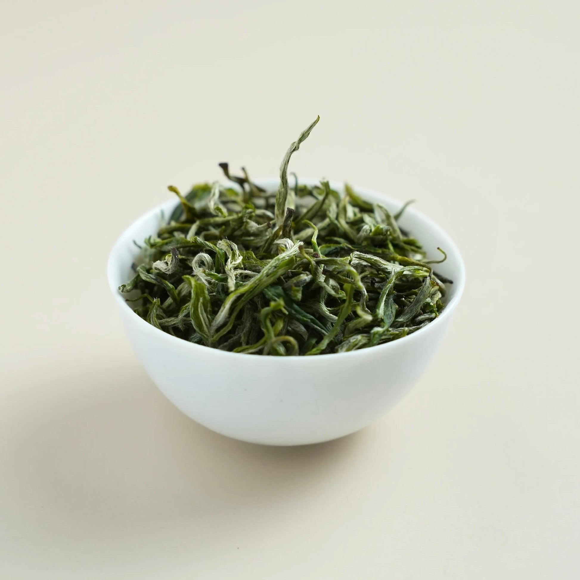 Premium Baojing Golden Green dry tea leaves close-up