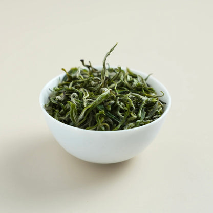 Premium Baojing Golden Green dry tea leaves close-up