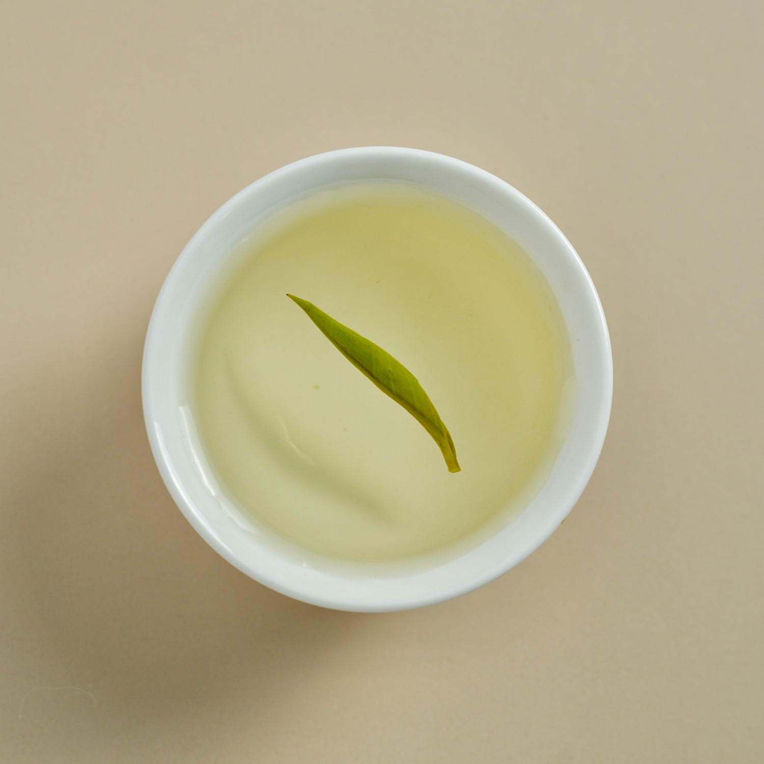 Baojing Golden Green brewed tea liquor in cup