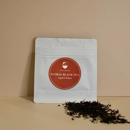 Floral Black tea pouch with loose-leaf black tea in front