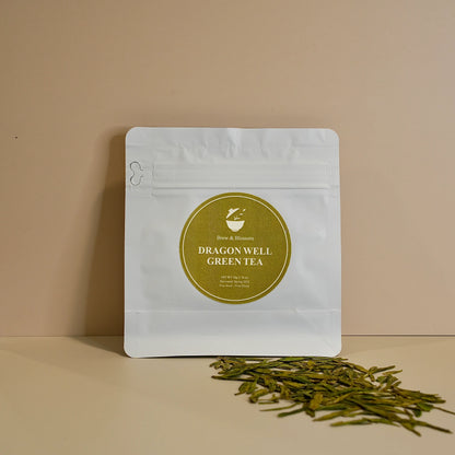 Dragon Well Green tea pouch with loose-leaf green tea in front