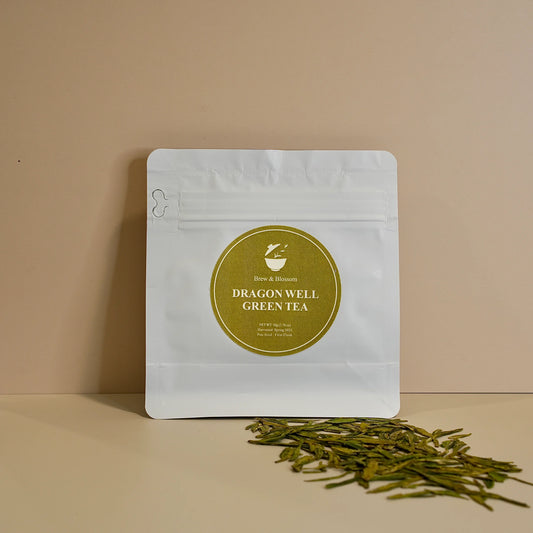 Dragon Well Green tea pouch with loose-leaf green tea in front